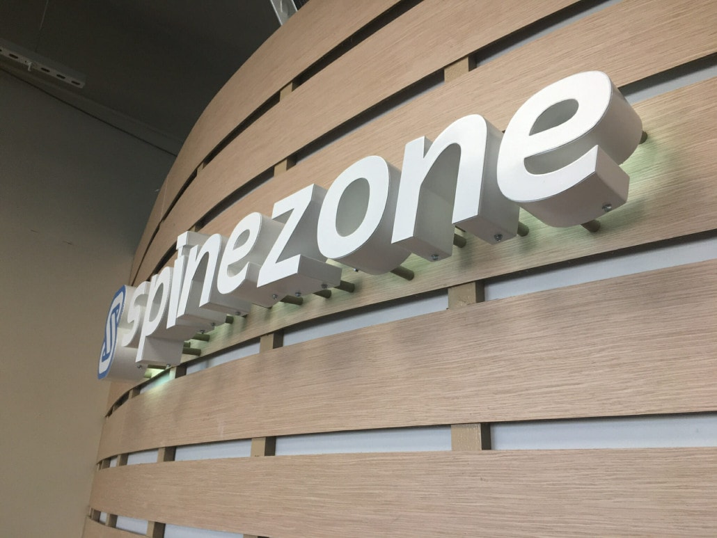 Curved wall with logo that reads Spinezone